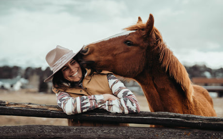 Horse sniffing woman's face